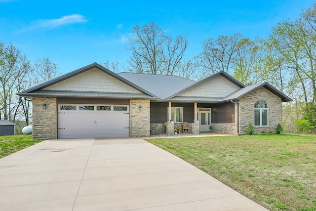 view of front of property with a front lawn, concrete driveway, an attached garage, and stone siding