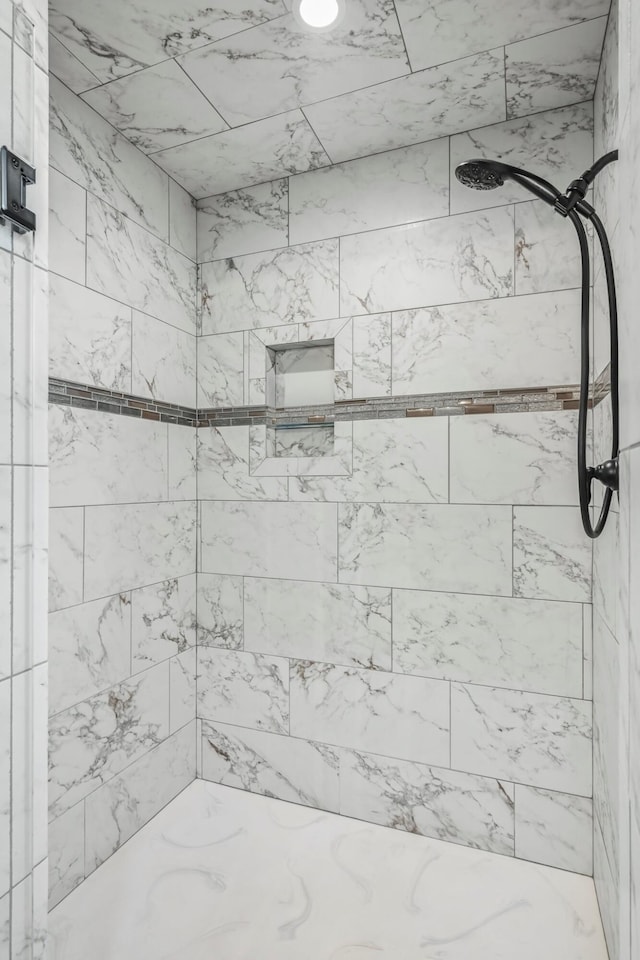bathroom with tiled shower