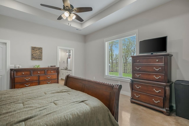 bedroom featuring baseboards, a ceiling fan, connected bathroom, and light colored carpet