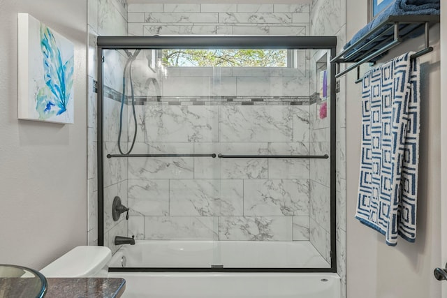 full bath with enclosed tub / shower combo and toilet