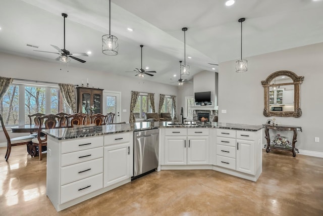 kitchen with stainless steel dishwasher, ceiling fan, open floor plan, and finished concrete floors