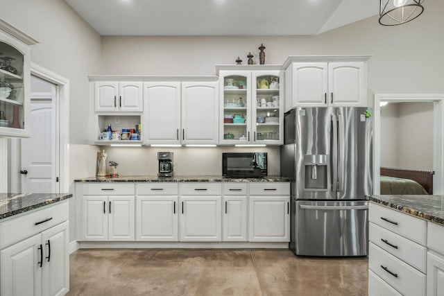 kitchen featuring dark stone countertops, glass insert cabinets, white cabinetry, black microwave, and stainless steel refrigerator with ice dispenser