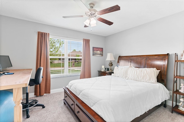 bedroom with light colored carpet, a ceiling fan, and baseboards