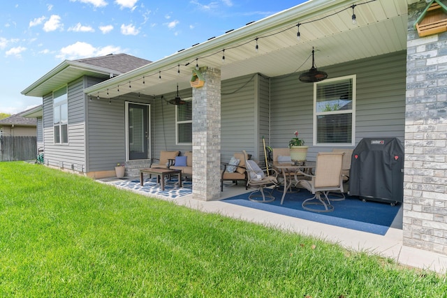 back of property with fence, a patio, roof with shingles, a lawn, and a ceiling fan