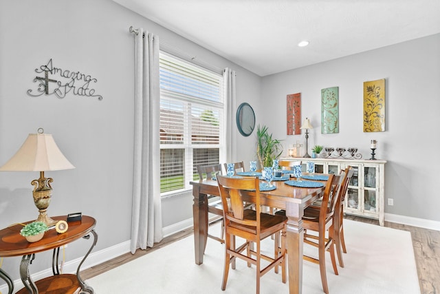 dining room with recessed lighting, light wood finished floors, and baseboards