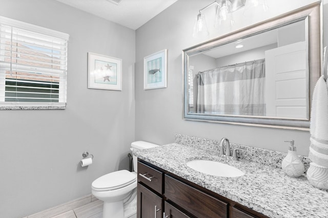 bathroom with baseboards, a shower with shower curtain, toilet, and vanity