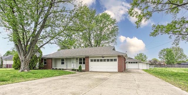 ranch-style house with concrete driveway, a front yard, fence, brick siding, and a garage