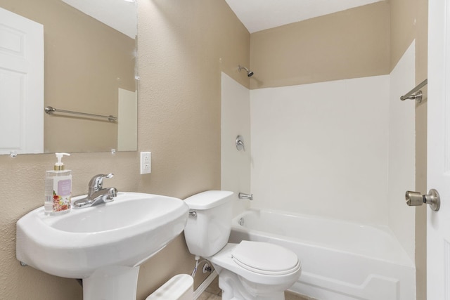 full bath with shower / bathing tub combination, toilet, a textured wall, and a sink