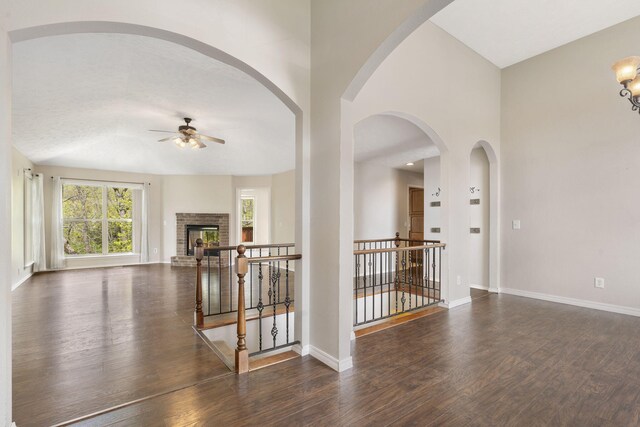 interior space with baseboards, wood finished floors, and ceiling fan