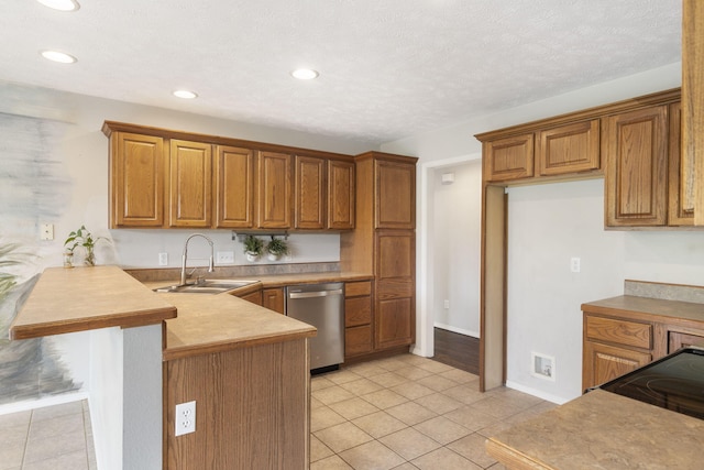 kitchen featuring a sink, light tile patterned flooring, dishwasher, a peninsula, and brown cabinetry