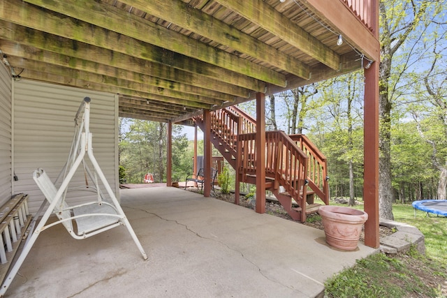 view of patio / terrace featuring stairs and a trampoline