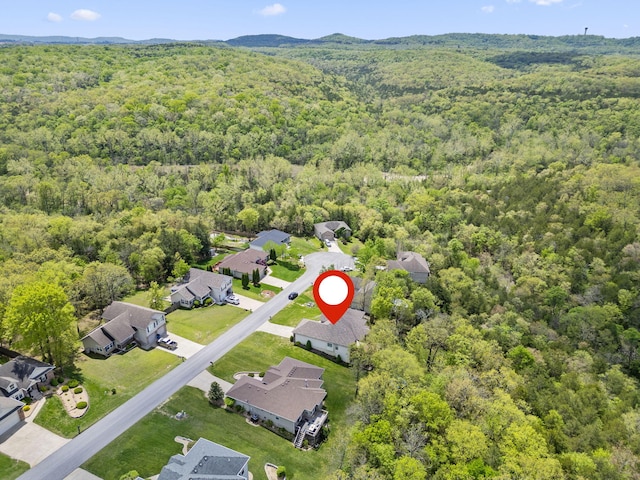 aerial view featuring a residential view and a wooded view