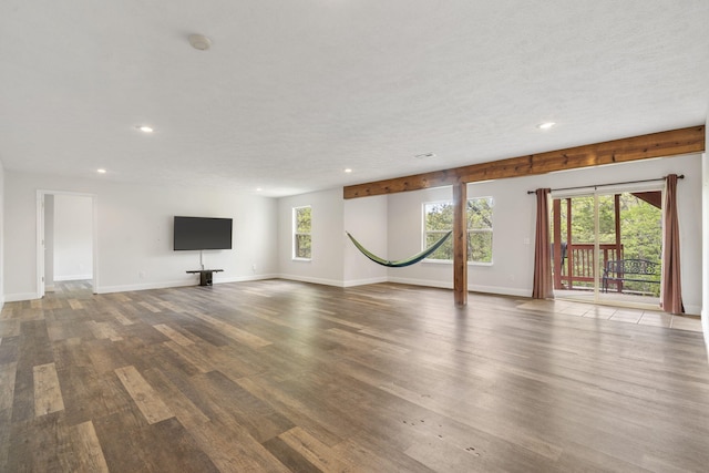 unfurnished living room featuring wood finished floors, recessed lighting, and baseboards