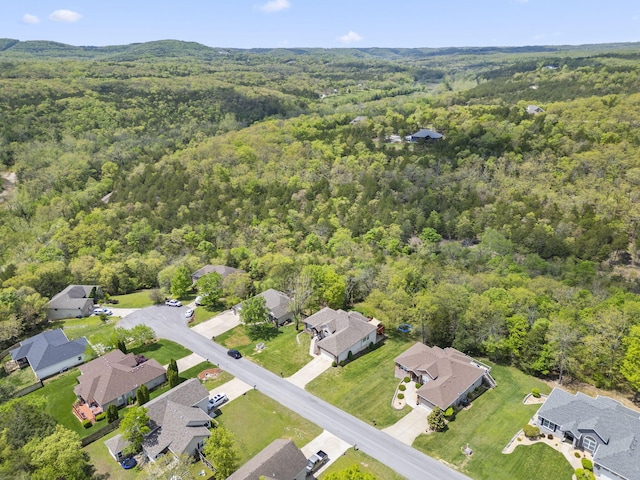 birds eye view of property featuring a wooded view and a residential view