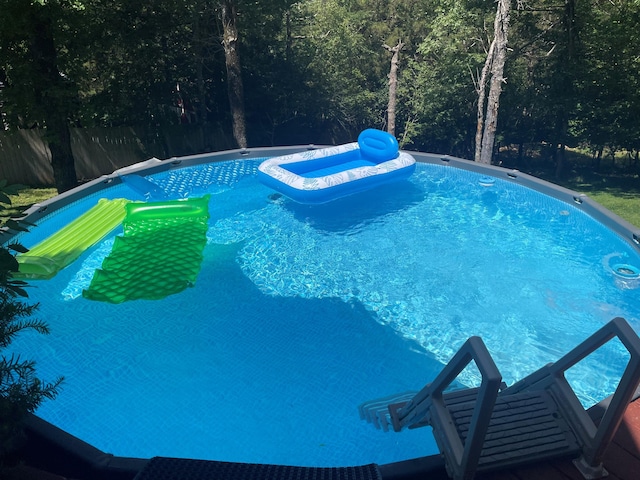 view of pool with a fenced in pool and fence