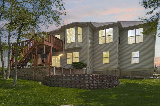 back of property featuring roof with shingles, a yard, stairs, and a wooden deck