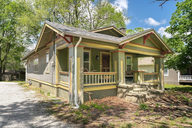 937 S Fremont Ave, Springfield, MO 65804 - bungalow-style house featuring covered porch, a chimney, and a shingled roof