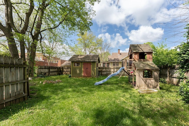 937 S Fremont Ave, Springfield, MO 65804 - view of yard with an outdoor structure, a fenced backyard, a shed, and a playground
