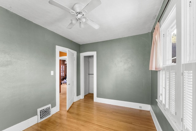 937 S Fremont Ave, Springfield, MO 65804 - spare room featuring visible vents, ceiling fan, wood finished floors, and baseboards