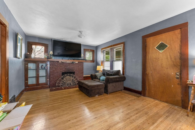 937 S Fremont Ave, Springfield, MO 65804 - living room with baseboards, light wood-type flooring, and a fireplace