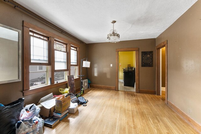 937 S Fremont Ave, Springfield, MO 65804 - interior space featuring a textured ceiling, a notable chandelier, baseboards, and light wood-type flooring