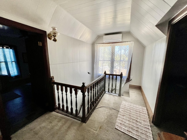 additional living space featuring carpet flooring, a wall mounted AC, and lofted ceiling