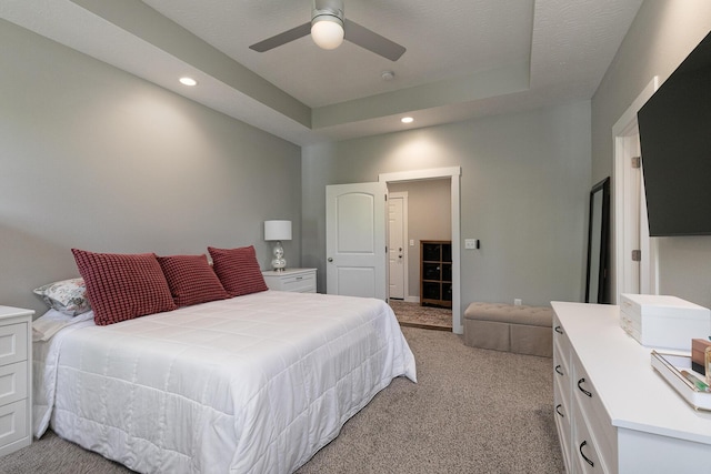 2460 S Durango Dr, Bolivar, MO 65613 - bedroom featuring light colored carpet, recessed lighting, a tray ceiling, and a ceiling fan