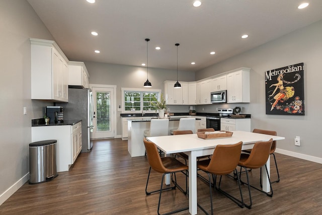 2460 S Durango Dr, Bolivar, MO 65613 - kitchen featuring white cabinets, appliances with stainless steel finishes, a kitchen island, baseboards, and recessed lighting