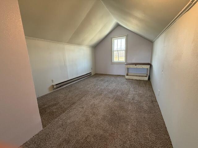 bonus room featuring lofted ceiling, a baseboard radiator, and carpet floors