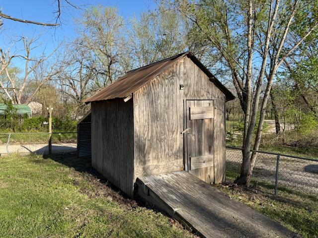 view of shed featuring fence