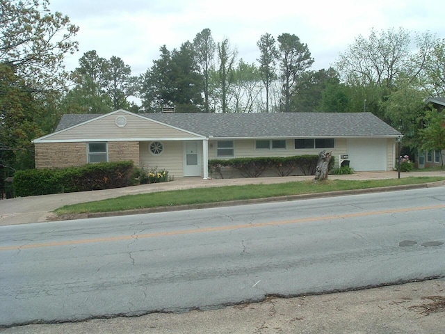 ranch-style home with driveway and a garage
