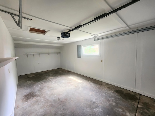 garage featuring electric panel and a garage door opener