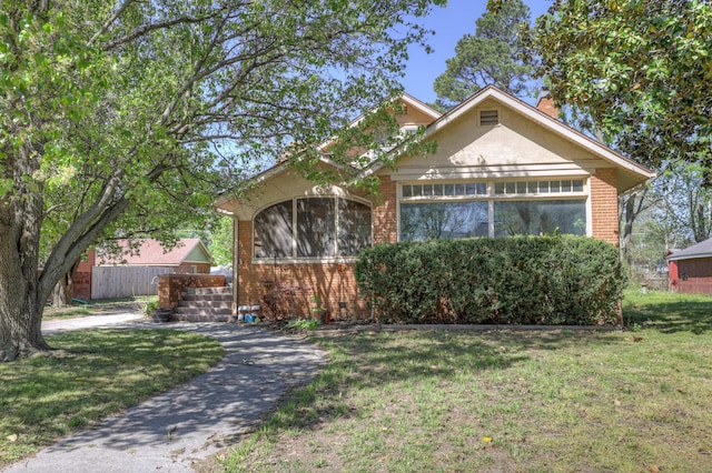 110 N Connor Ave, Joplin, MO 64801 - view of front of property featuring a chimney, a front yard, and brick siding