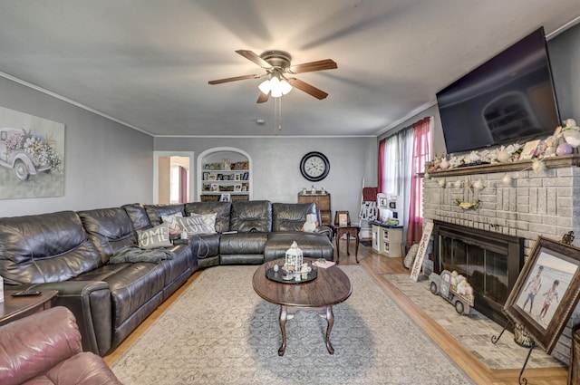 110 N Connor Ave, Joplin, MO 64801 - living room featuring crown molding, ceiling fan, a brick fireplace, wood finished floors, and built in features