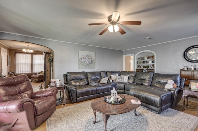 110 N Connor Ave, Joplin, MO 64801 - living room with light wood finished floors, built in shelves, ornamental molding, arched walkways, and ceiling fan with notable chandelier