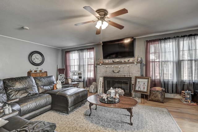 110 N Connor Ave, Joplin, MO 64801 - living area featuring wood finished floors, ceiling fan, ornamental molding, and a brick fireplace