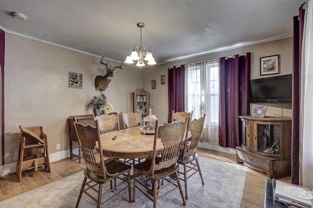 110 N Connor Ave, Joplin, MO 64801 - dining space with ornamental molding, an inviting chandelier, and wood finished floors
