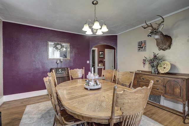 110 N Connor Ave, Joplin, MO 64801 - dining area featuring an inviting chandelier, wood finished floors, ornamental molding, and arched walkways