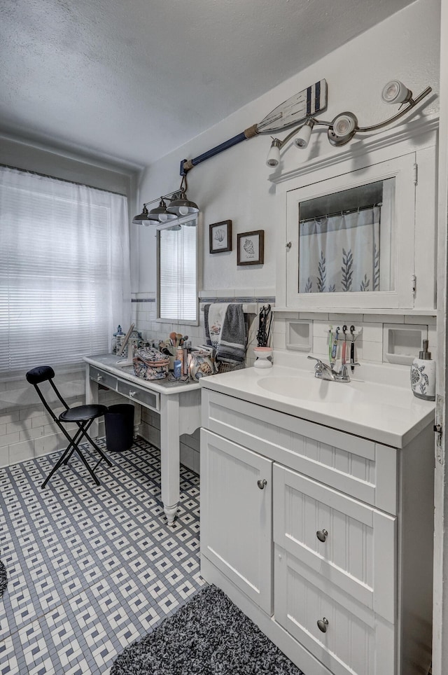 110 N Connor Ave, Joplin, MO 64801 - full bathroom with a textured ceiling, a sink, and decorative backsplash