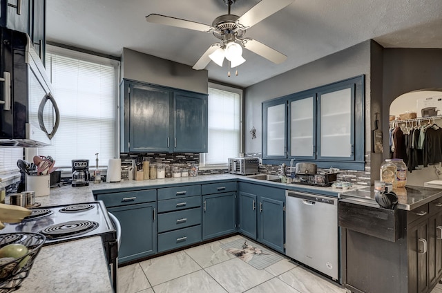 110 N Connor Ave, Joplin, MO 64801 - kitchen with blue cabinetry, appliances with stainless steel finishes, light countertops, ceiling fan, and a sink