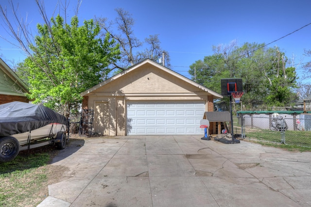 110 N Connor Ave, Joplin, MO 64801 - view of side of property with an outbuilding, a detached garage, stucco siding, and fence