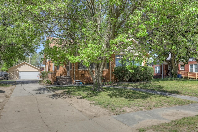 110 N Connor Ave, Joplin, MO 64801 - obstructed view of property with a garage, brick siding, an outdoor structure, and a front yard