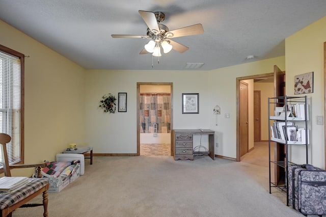 sitting room with visible vents, ceiling fan, baseboards, and carpet floors
