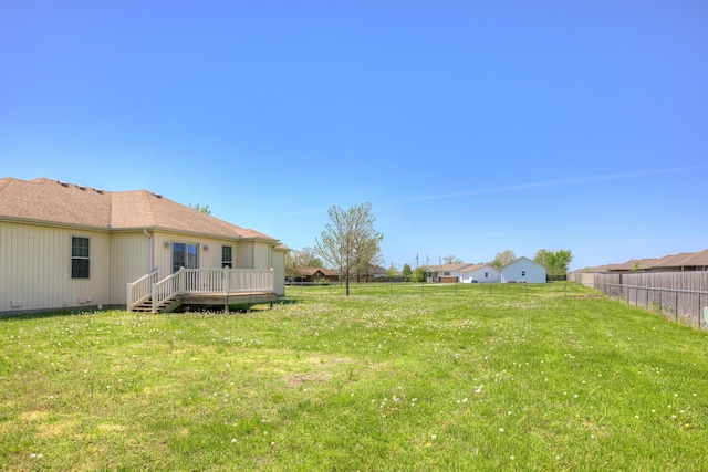 view of yard featuring a wooden deck and fence