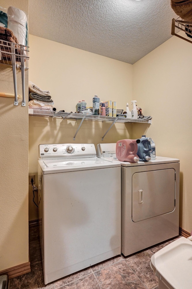 washroom featuring a textured ceiling, independent washer and dryer, and laundry area