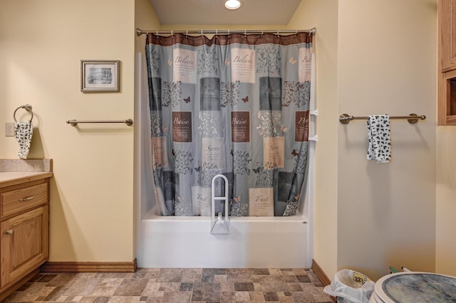 bathroom with shower / bath combo, vanity, recessed lighting, and baseboards