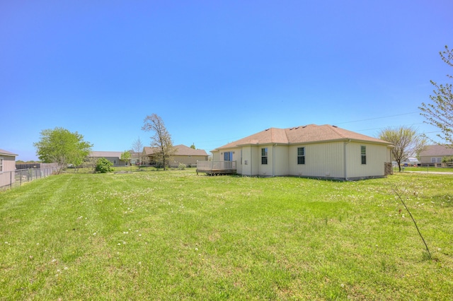 view of yard with a deck and fence