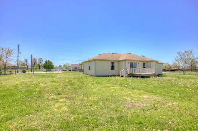 view of yard with fence and a wooden deck