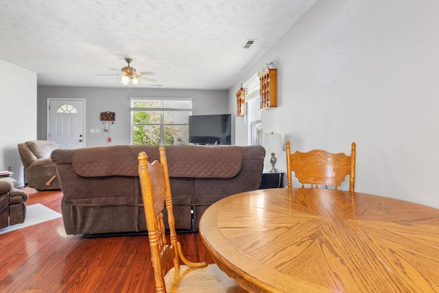 317 Hickory St, Merriam Woods, MO 65740 - dining room with a ceiling fan, visible vents, wood finished floors, and a textured ceiling