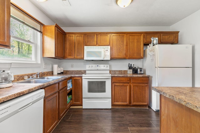317 Hickory St, Merriam Woods, MO 65740 - kitchen with brown cabinetry, white appliances, dark wood-style flooring, and a sink